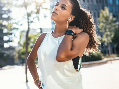 Jeune femme ressentant une douleur à l'épaule lors d'une session de course à pied